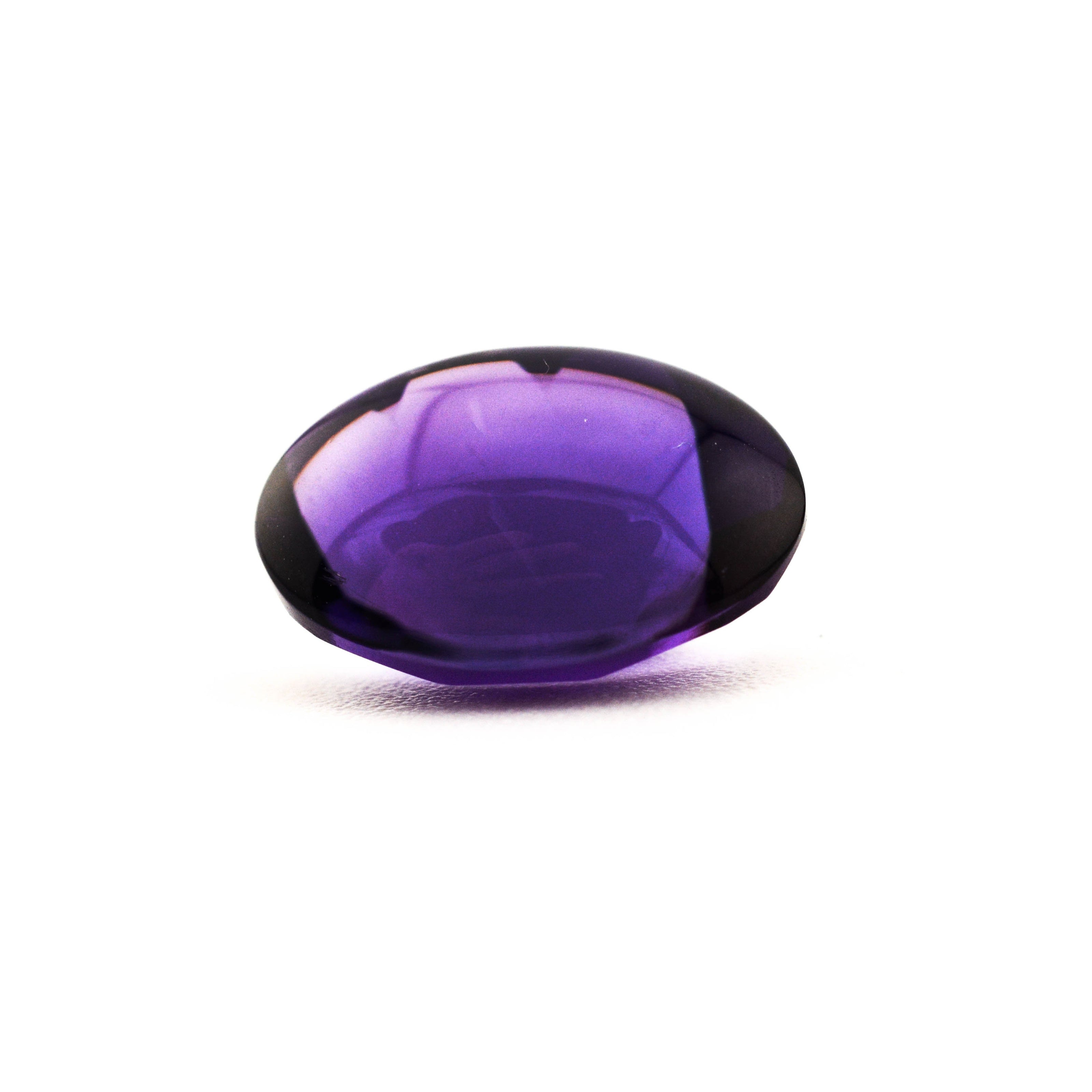 Purple gemstone on a white background