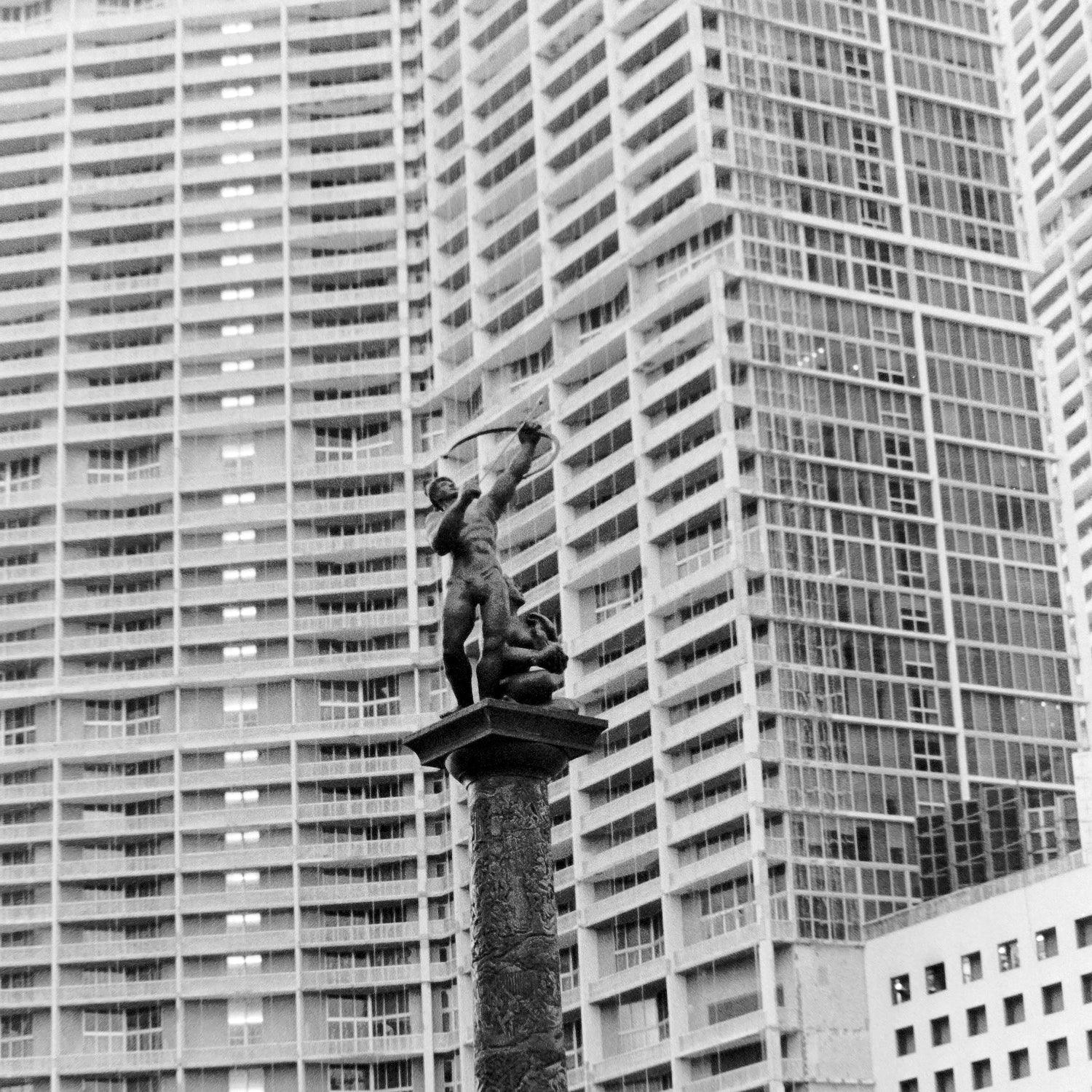 Black and white photograph of a statue in Brickell.