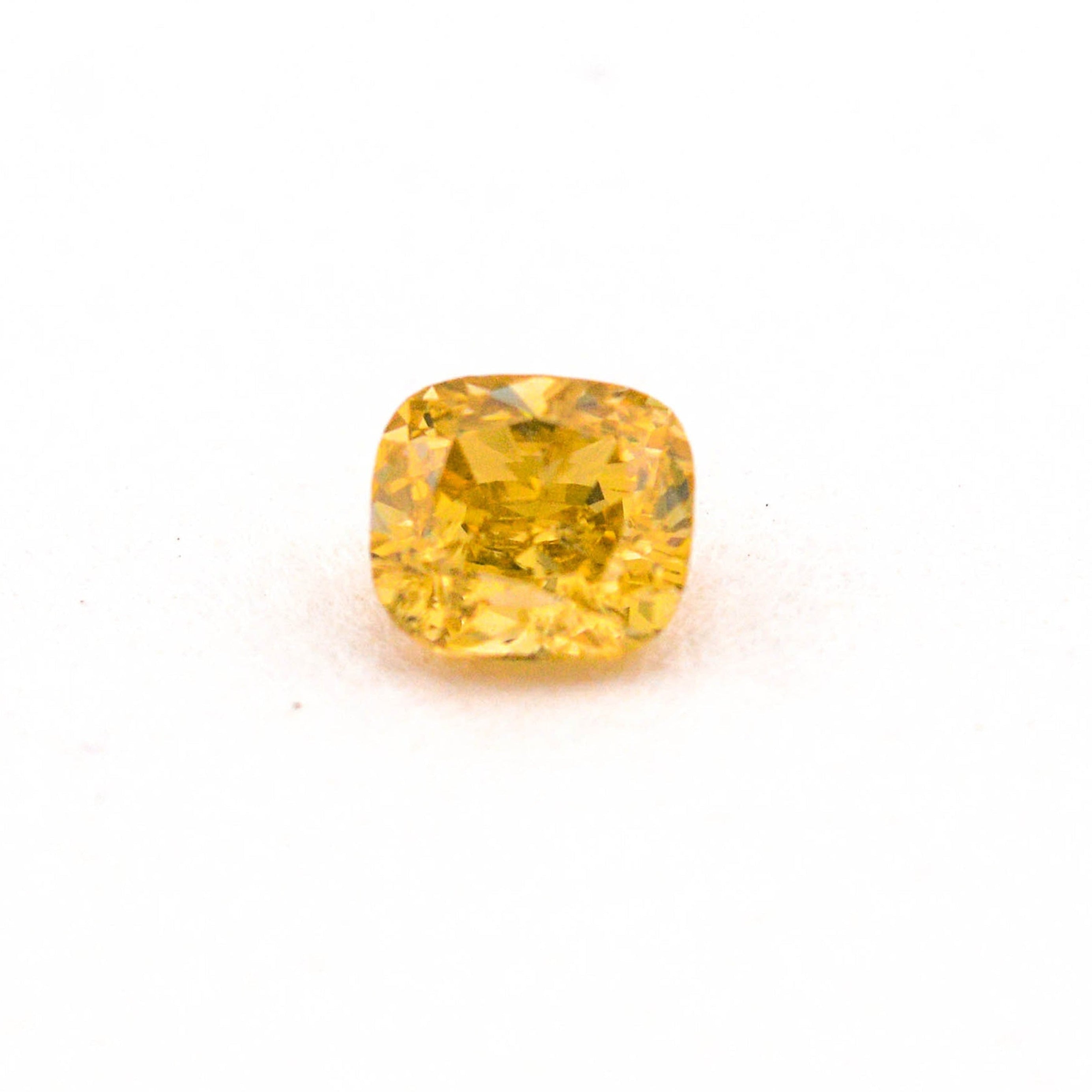 Yellow gemstone on a white background
